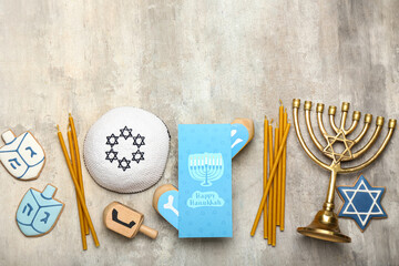 Different symbols of Hanukkah and greeting card on grunge background