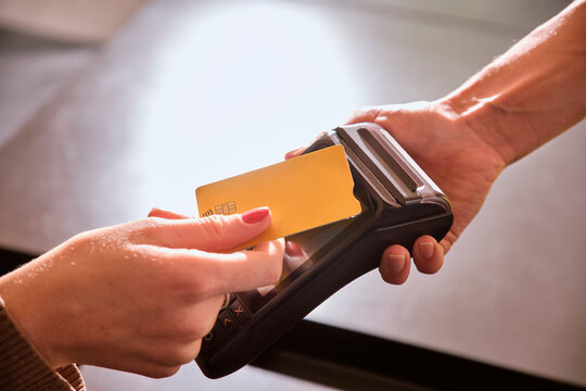 Woman making contactless payment at restaurant