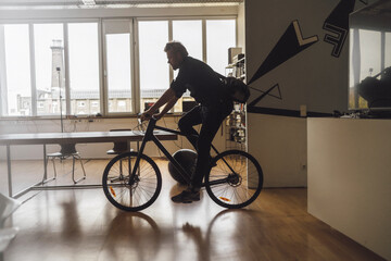 Man entering office with his bicycle