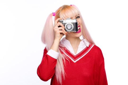 Cheerful fashionable woman photographing through vintage camera