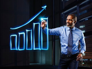 Businessman painting upturning bar chart with light