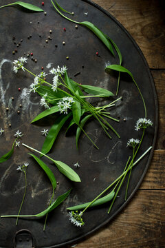 Ramson and peppercorns on rustic baking sheet