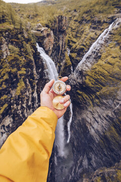 Hand holding compass in Norway