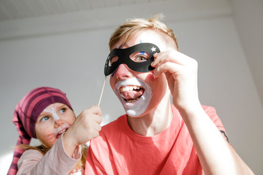 Portrait of boy and little sister made up for carnival