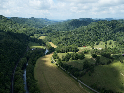 Drone view of Clinch River surrounded by forested hills in summer