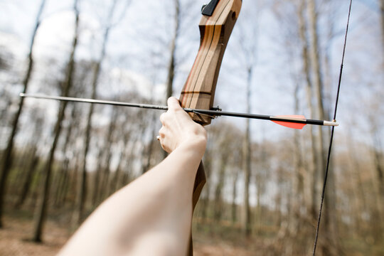 Hand of archeress holding bow and arrow