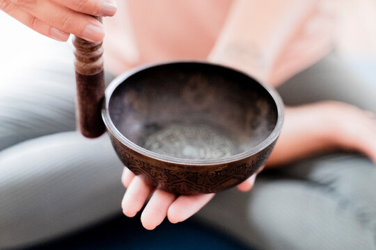 Woman playing singing bowl