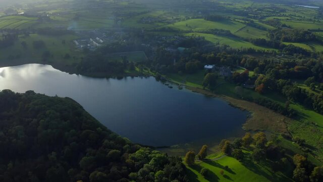 Castle Leslie Estate, Glaslough, Monaghan, Ireland, October 2021. Drone gradually pushes northwest towards the house from the eastern side of the lake.