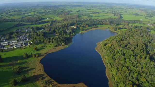 Castle Leslie Estate, Glaslough, Monaghan, Ireland, October 2021. Drone gradually pushes north towards the house from across the lake.