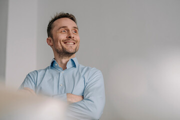 Portrait of a successful businessman, smiling with arms crossed