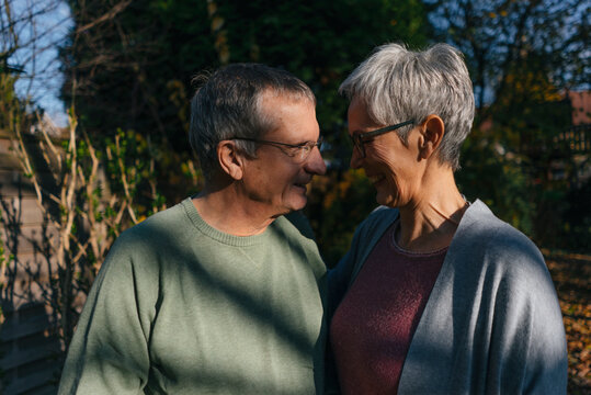 Affectionate senior couple facing each other in garden