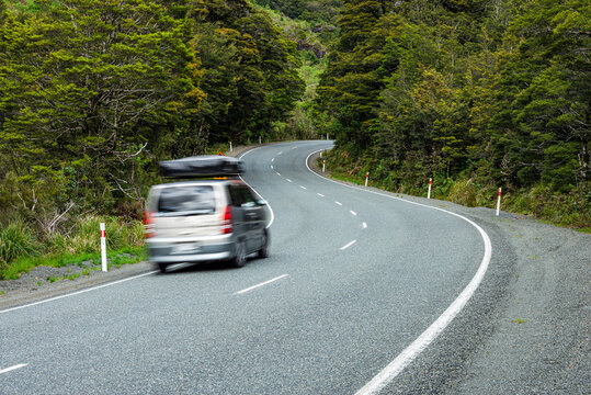 Fototapeta New Zealand, Southland, Blurred motion of car driving along State Highway 94 in Fiordland National Park