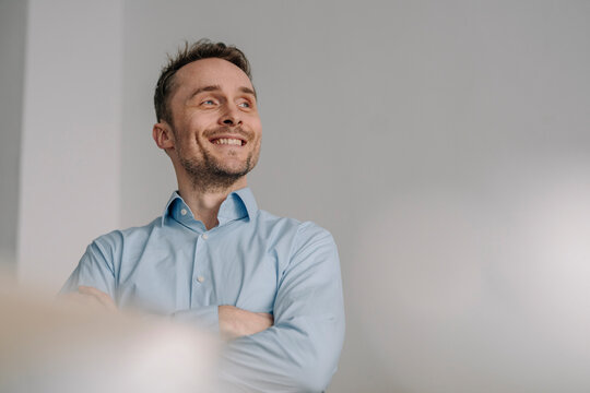 Portrait of a successful businessman, smiling with arms crossed