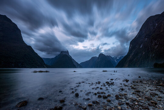 New Zealand, Southland, Long exposure of storm clouds over scenic coastline of Milford Sound