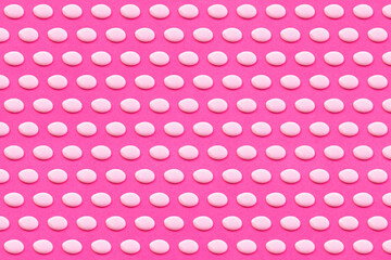 Pattern of white liquid drops against vibrant pink background