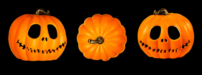 Three Isolated Pumpkin head Jack-o'-lantern close-up on black background 