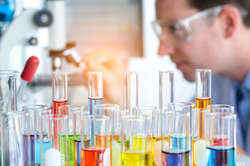 Hand of Scientists experimenting with chemicals In the laboratory to invent Vaccine for treatment of disease. Concept of health and medicine.