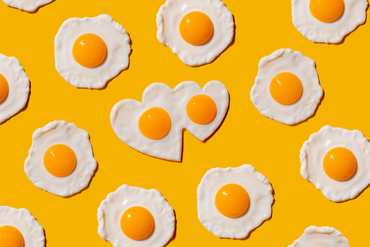 Pattern of fried eggs against yellow background