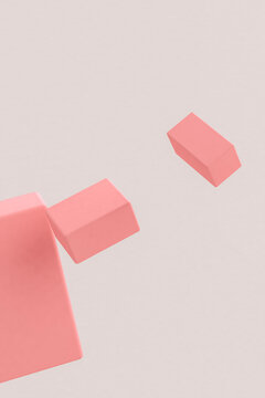 Three dimensional render of pink cuboids floating against gray background