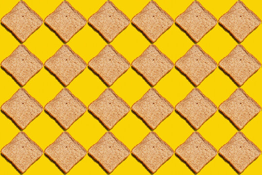 Pattern of slices of wheat bread against yellow background