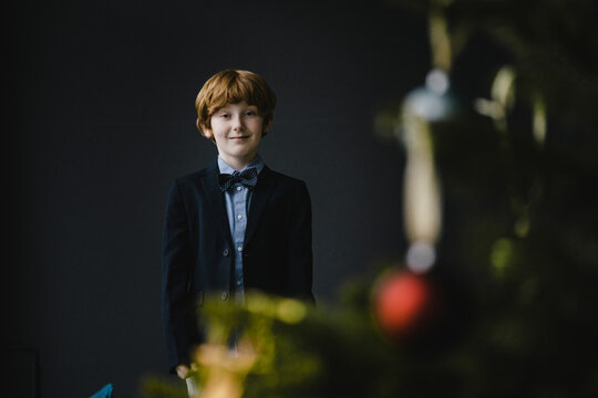 Portrait of redheaded boy wearing bow tie at Christmas time