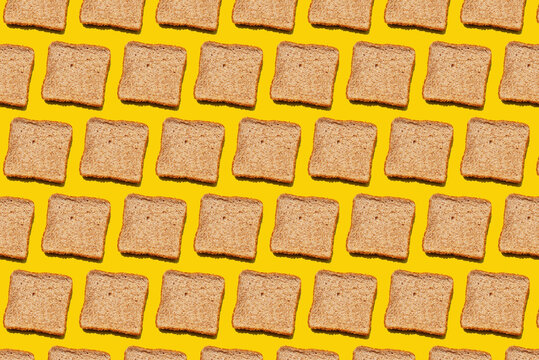 Pattern of slices of wheat bread against yellow background