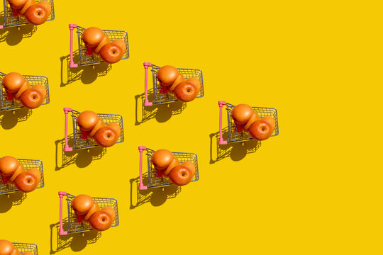Pattern of fresh apricots inside miniature shopping carts