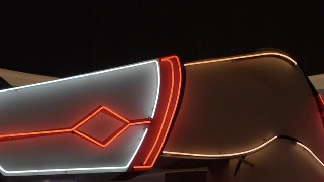 This panning video features a large and kitschy neon cowgirl sign.