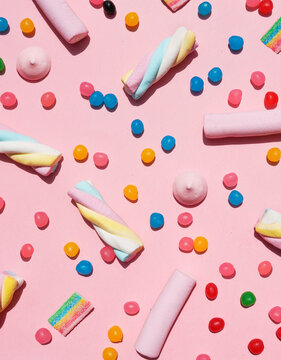Various sweets against pink background