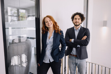 Portrait of confident businessman and businesswoman in office