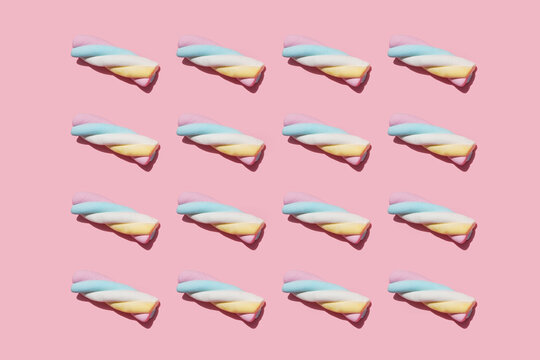 Pattern of marshmallows against pink background