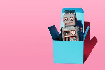 Studio shot of vintage robot toy in turquoise gift box