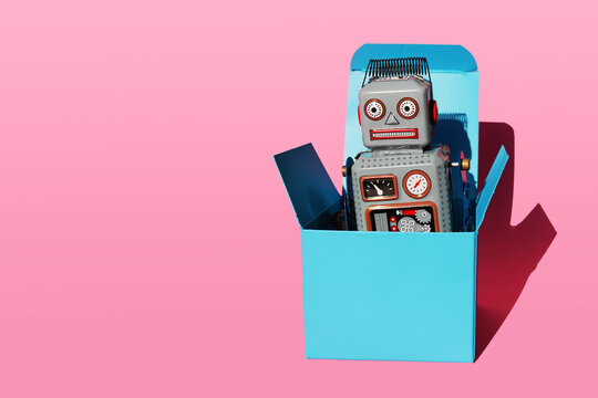 Fototapeta Studio shot of vintage robot toy in turquoise gift box