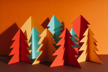 Studio shot of simple paper craft forest trees in autumn colors