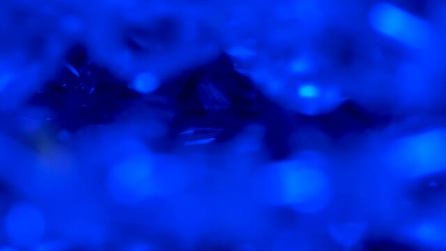 Magic background surfaces kaleidoscope. Beautiful diamond. Crystal prism refracting light in vivid blue colors. Magic background for holiday or party