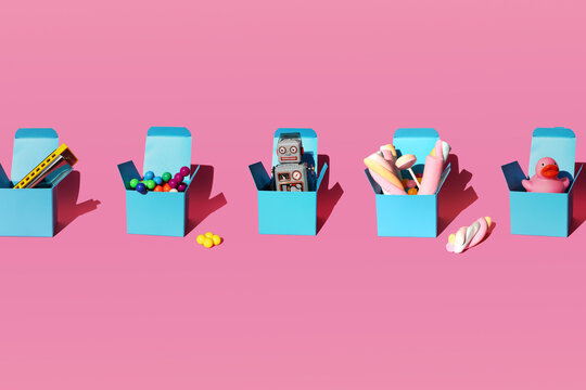 Studio shot of five gifts consisting of harmonica, plastic spheres, vintage robot toy, sweets and rubber duck