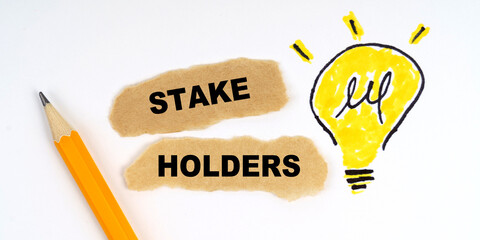 A lamp is drawn on a white sheet, there is a pencil and scraps of paper on which it is written - STAKE HOLDERS