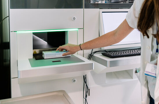 Close-up of doctor taking medicines through dispensing system in hospital