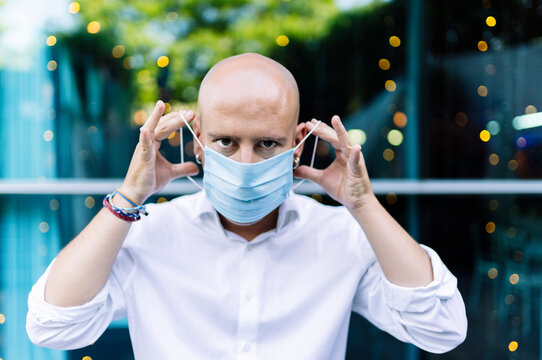 Bald man wearing protective mask responsibly