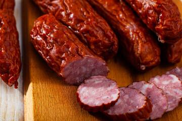 Pile of Czech dried sausages on wooden table