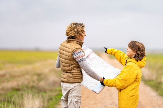 Two brothers checking map during hike