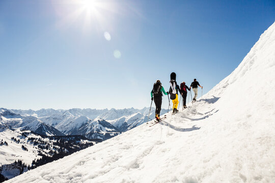 Group of friends ski touring up to a mountain peak, Achenkirch, Austria