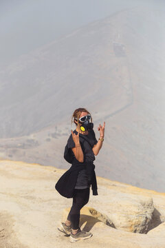 Young woman with espirator mask at Ijen volcano, Java, Indonesia