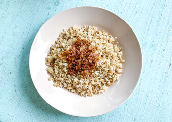 Nasi Goreng or fried rice with fried onions as a topping indonesia food.