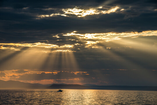 Sun breaking through the clouds above the Amur in Vladivostok, Russia