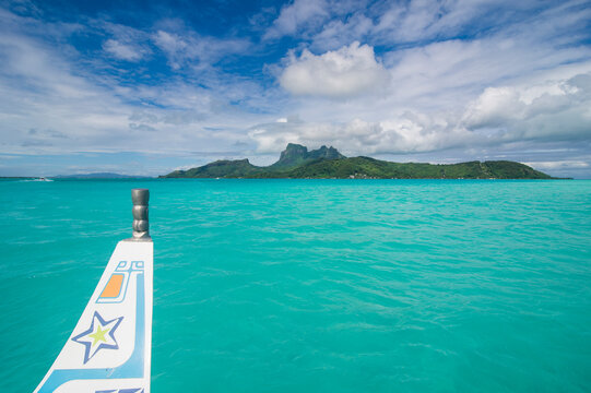 French Polynesia, Bora Bora, Little boat in the turquoise lagoon