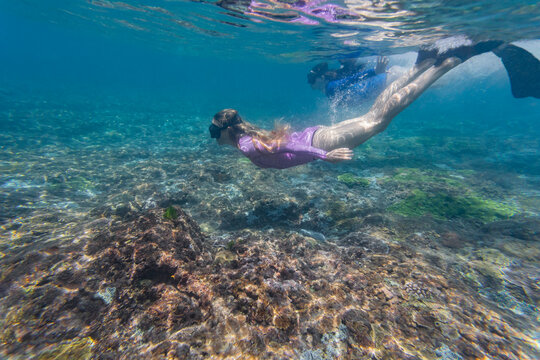 Two young women snorkeling in Nusa Penida island, Bali, Indonesia