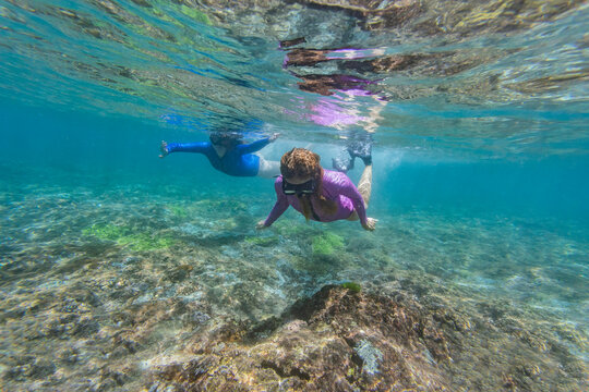 Two young women snorkeling in Nusa Penida island, Bali, Indonesia