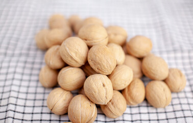 A lot of whole walnuts on a napkin close-up. Healthy, organic and healthy food with a high content of protein and protein.
