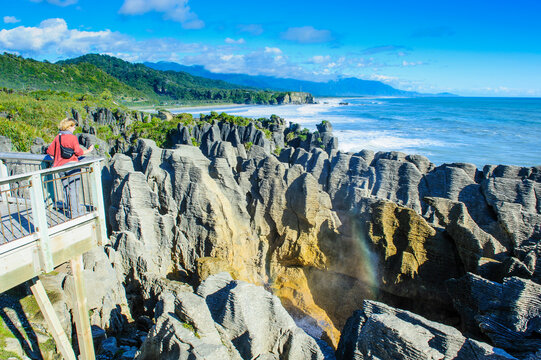 Woman on viewing platform at Pancake Rocks, Paparoa National Park, South Island, New Zealand